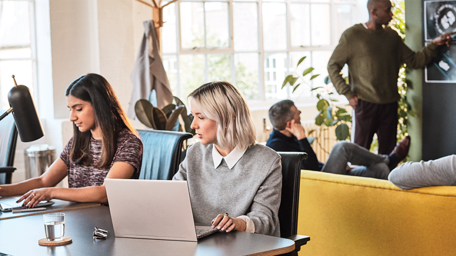 Image of a group of Firstline Workers working together in an open space work environment.