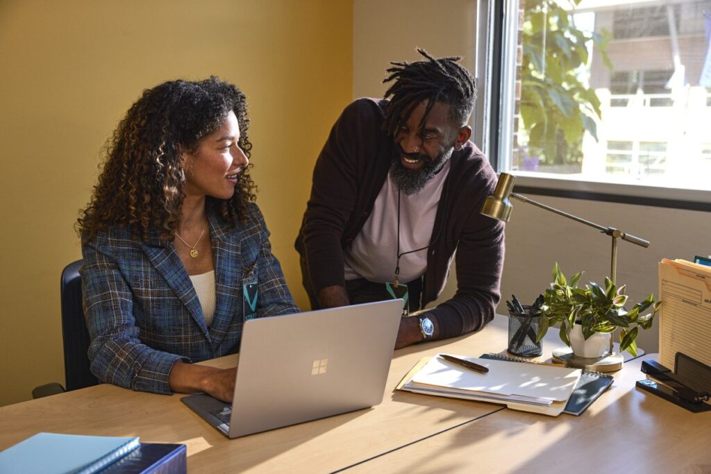 Two education leaders collaborating in an office at a higher education institution.