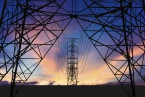 Utility towers and power lines against an evening sky