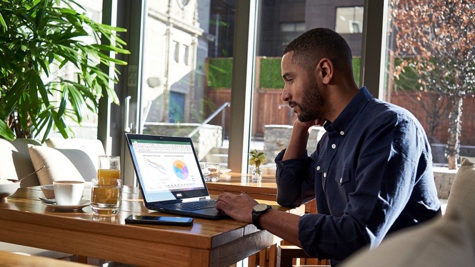 Image of a remote worker working at his desk. An Excel spreadsheet is open.