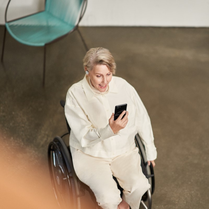 A woman participating in a Microsoft Teams meeting on her mobile device while on the go.