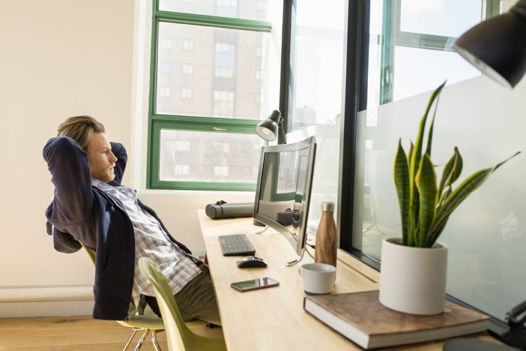 Young, small business male with All-in-one in modern workplace.