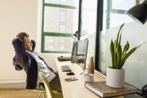 Young, small business male with All-in-one in modern workplace.