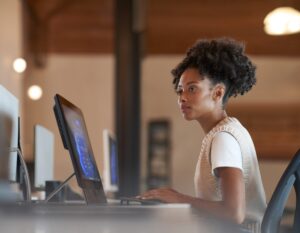 Person sitting at computer in a workspace