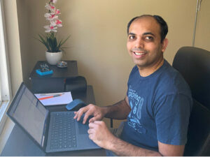 Ajay Dandage looks at the camera and smiles.
