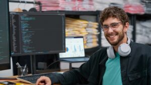 Engaged developer portrait in the context of retail warehouse, with screen showing data powered by Azure.