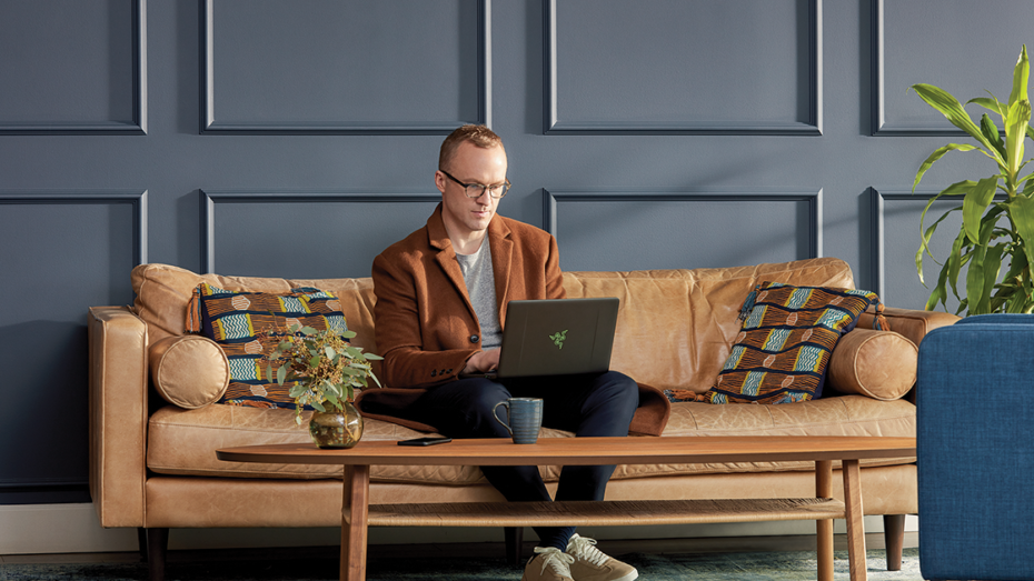 Image of a man working on a couch.