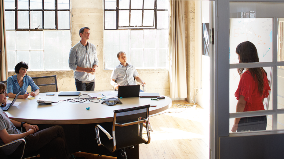 Image of four coworkers collaborating in an office.