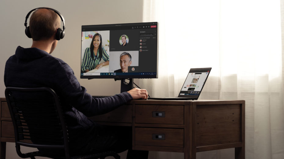 Teams call with headphones at a home desk on a Lenovo ThinkPad X1 Carbon.